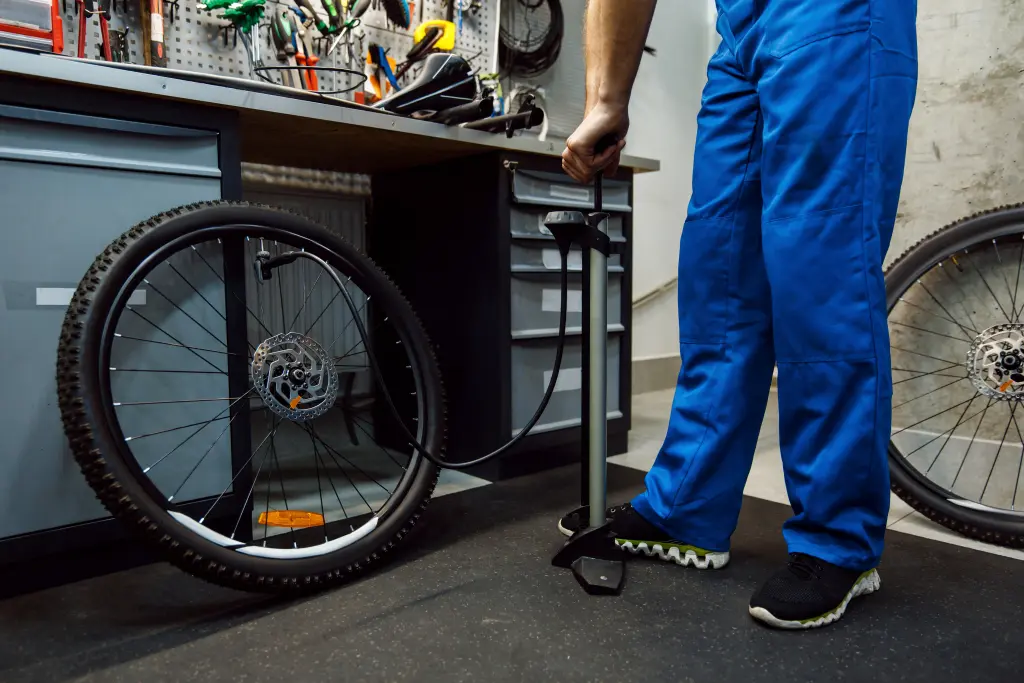 bicycle-assembly-workshop-man-inflates-wheel.jpg